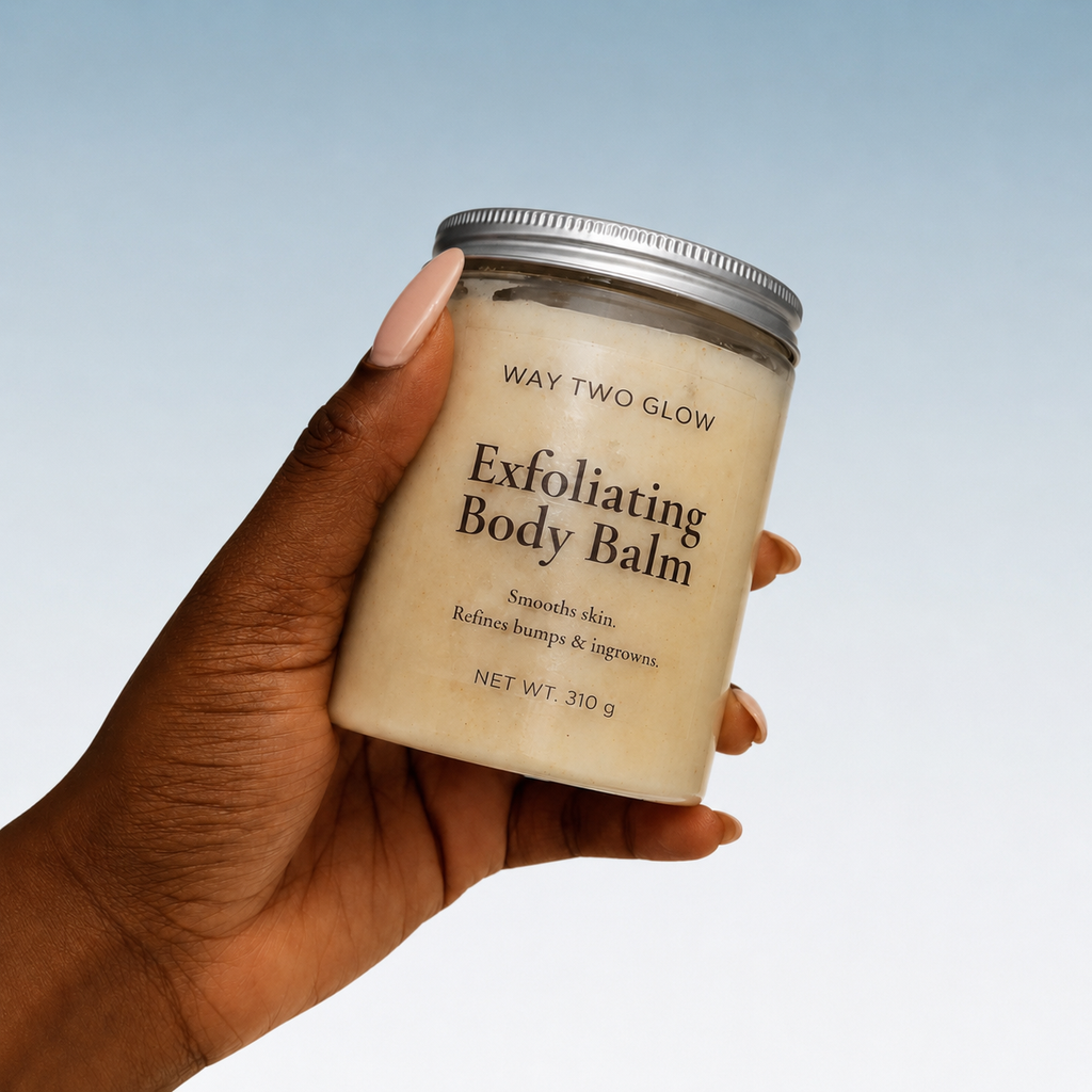 Hand holding a jar of 'Way Two Glow' exfoliating body balm against a light blue background